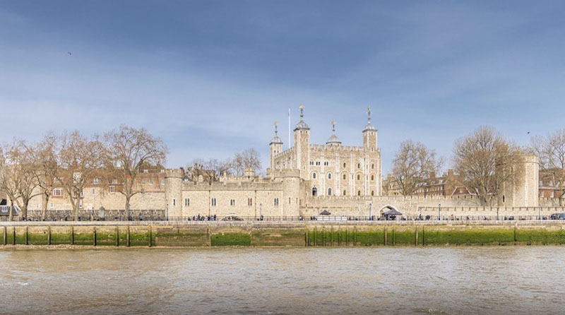 view of the tower of london from thames river