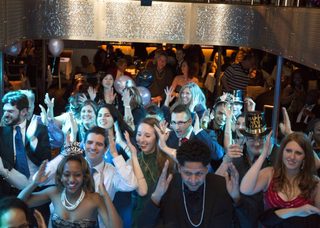 people dancing with new years hats