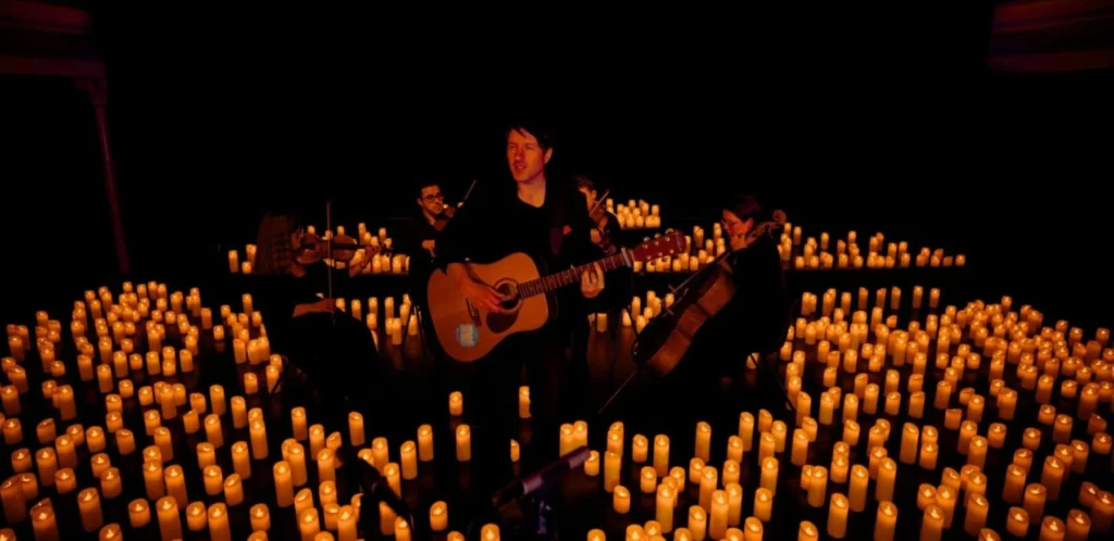 musician playing on candlelit stage