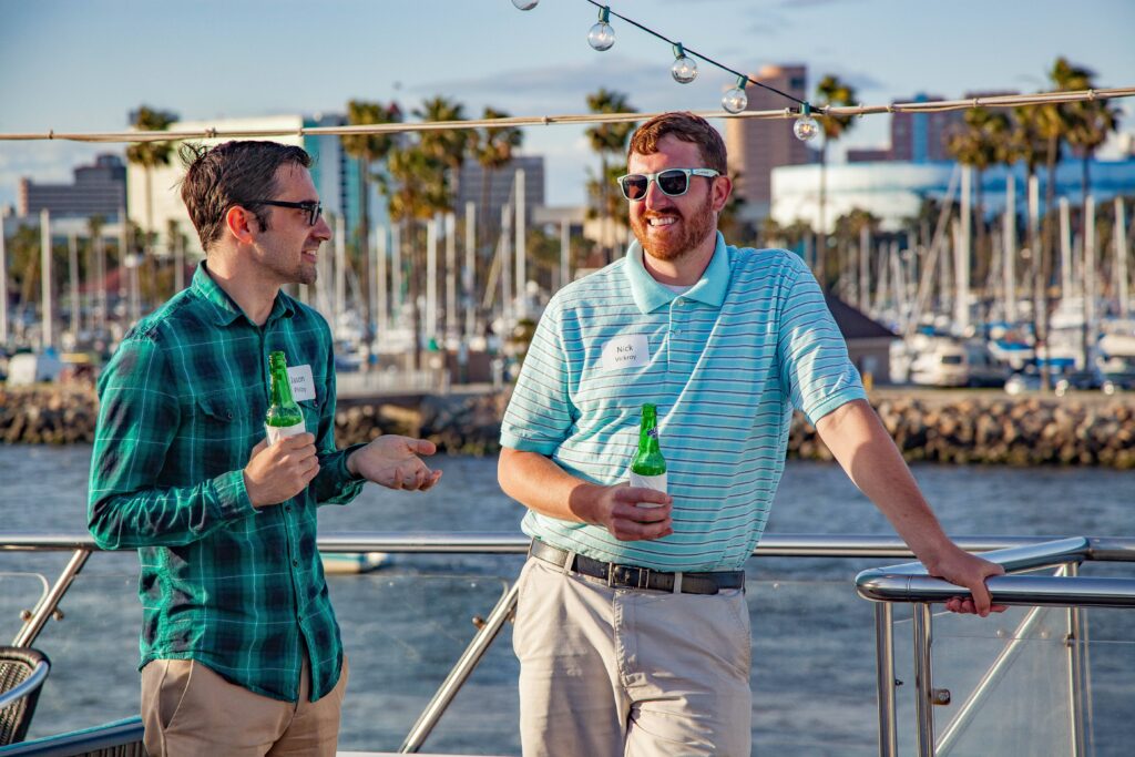 2 men on deck with drinks long beach
