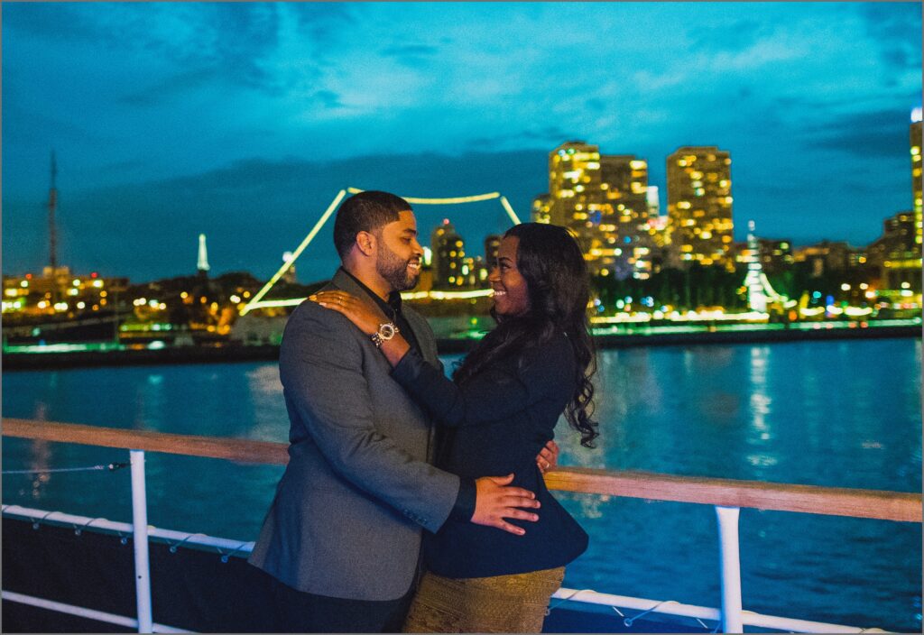 couple in front of delaware bridge on boat