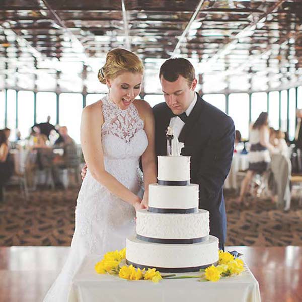 bride and groom cutting cake on city cruises vessel