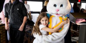 Easter bunny hugging girl on boat