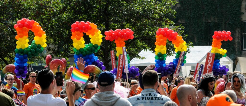 pride balloons with people holding