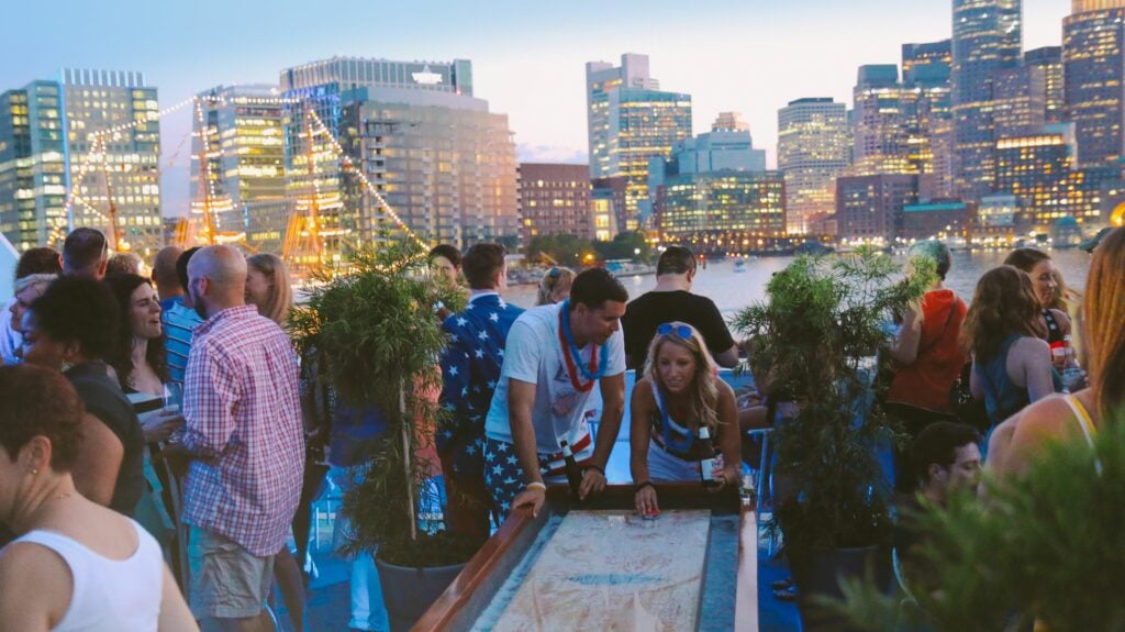 group playing a game with boston skyline