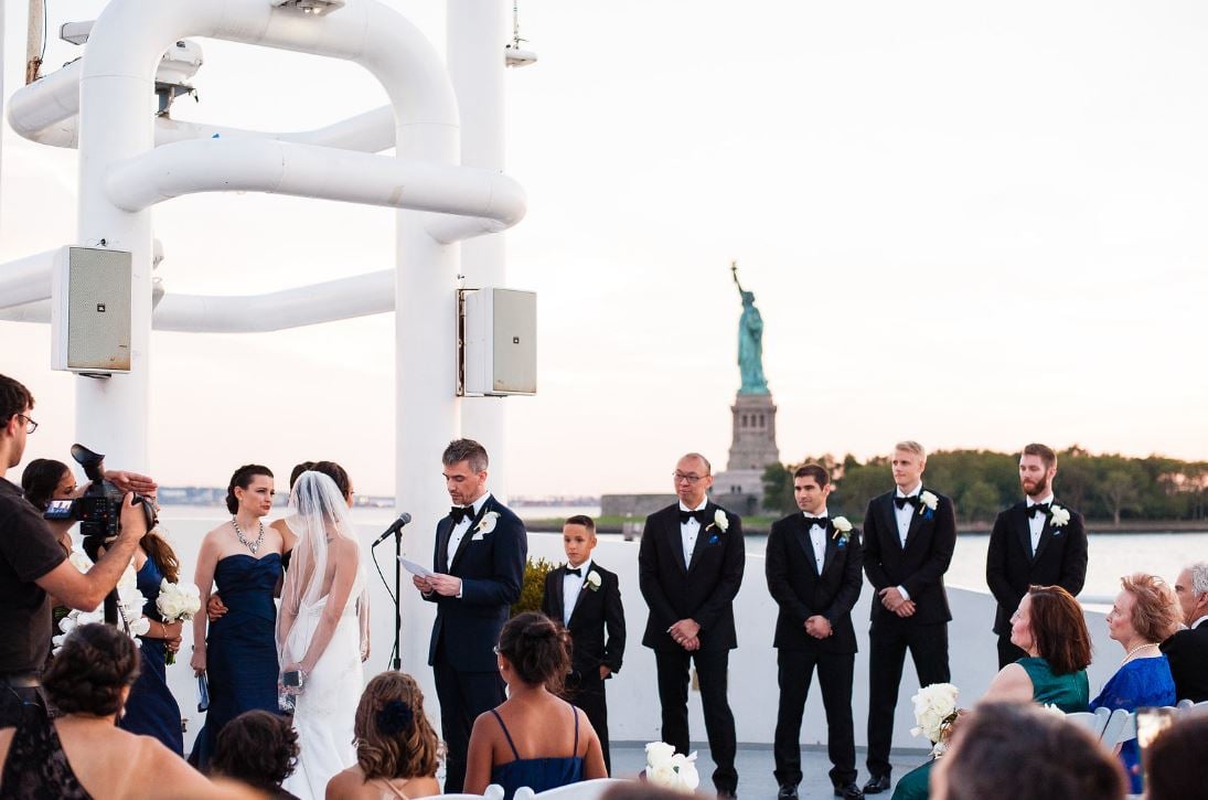 Wedding on City Cruises with the Statue of Liberty in the background