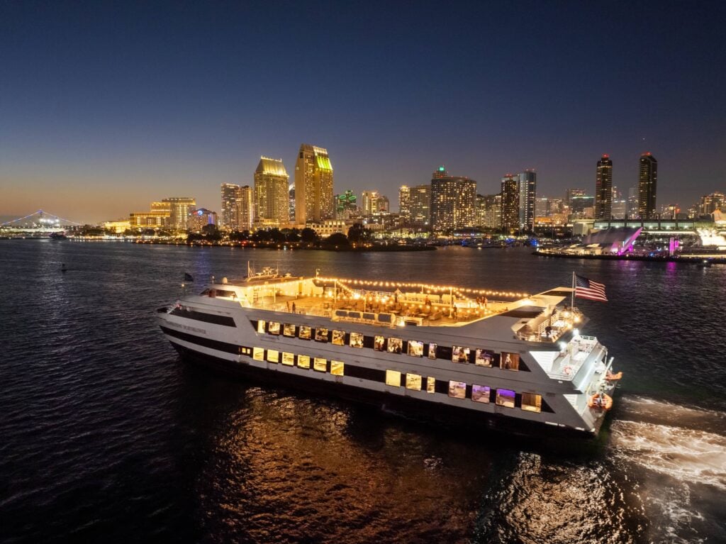 San Diego skyline at night with City Cruises vessel in the foreground