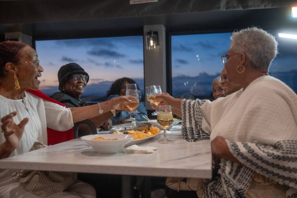 Group toasting at a retirement party on City Cruises vessel