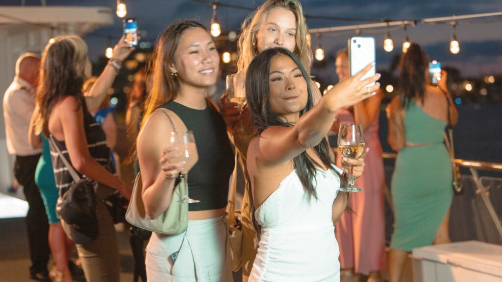 women taking selfie on boat