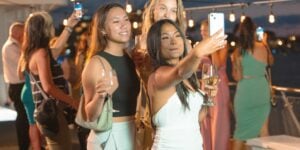 women taking selfie on boat