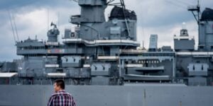 Guest onboard City Cruises overlooking military ship in Philadelphia