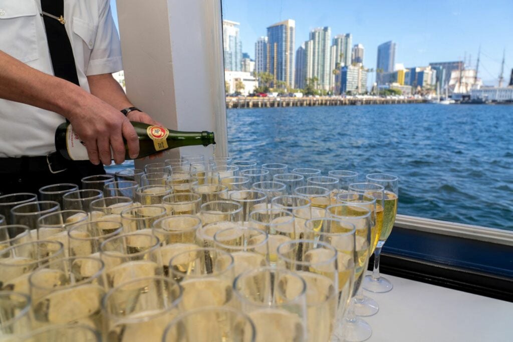 champagne being poured with san diego in back ground