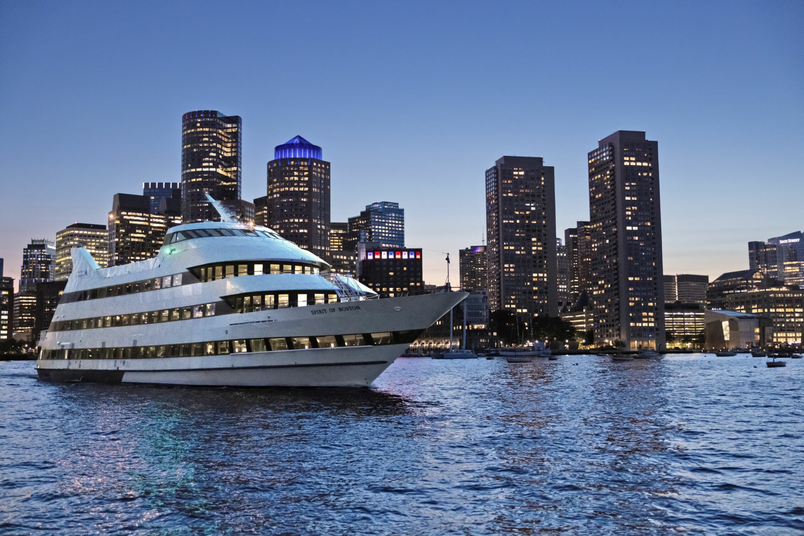 spirit of boston nightime exterior with skyline